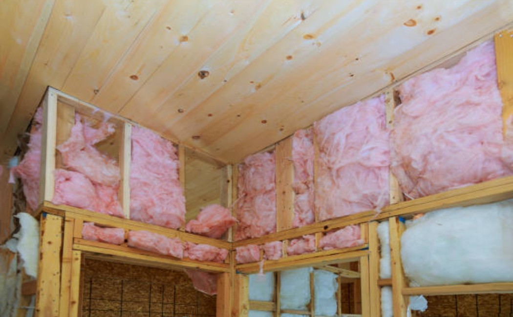Unfinished wall with mineral wool insulation slab between vertical wood beams