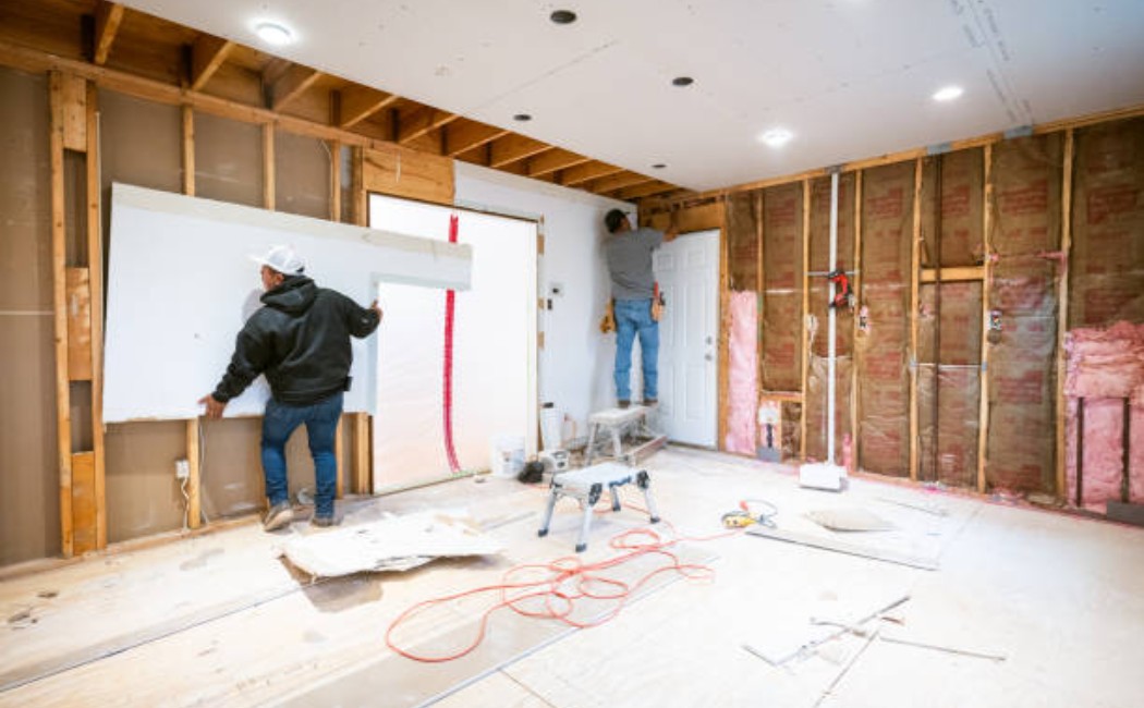 Drywall installers working on a kitchen renovation project