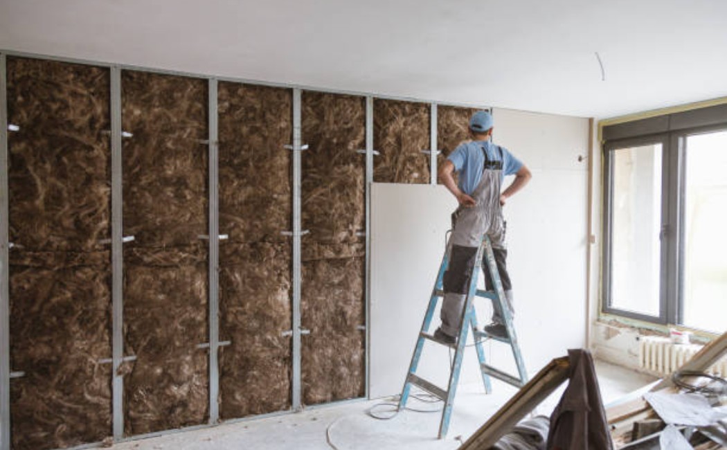 Workers wearing reflective vests and helmets performing structural work