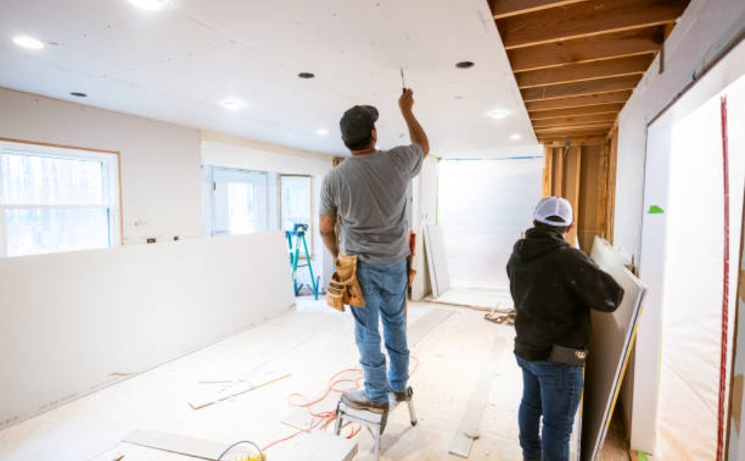 Professional drywall installation in progress in a kitchen space