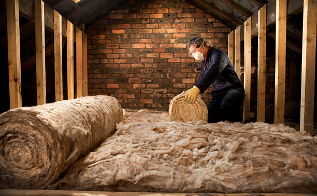 Attic space showing new thermal insulation installed under a pitched roof.