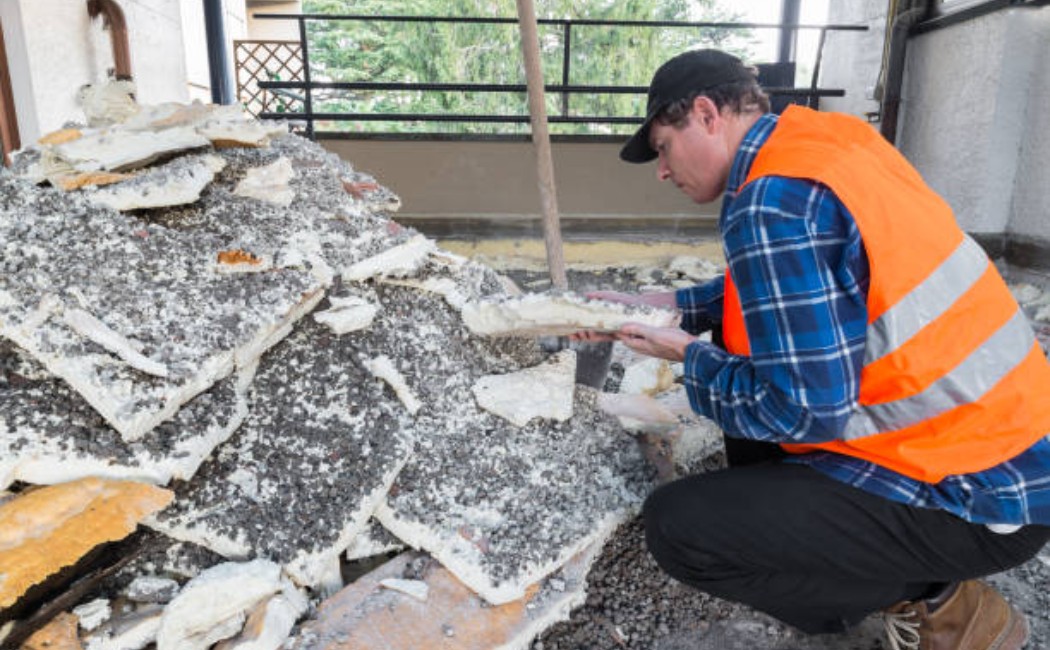 Debris and insulation removed during home repair on a rooftop terrace.