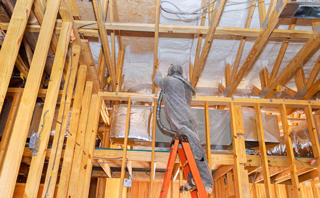 Spray foam insulation on the wooden ceiling structure