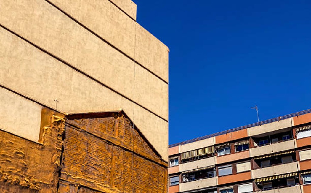 Insulation foam is being sprayed to form the shape of a house.